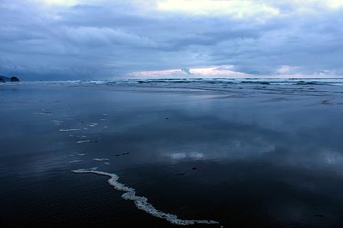 Moody sky reflected in Cannon Beach waters