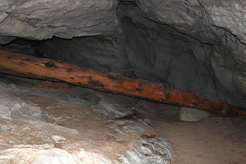 Log jammed into the sea cave