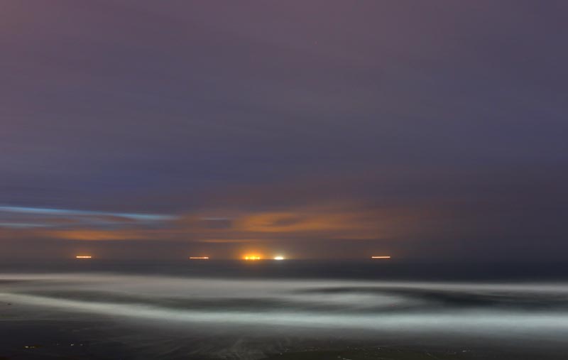 Fishing boat lights and ethereal glow at night, Depoe Bay