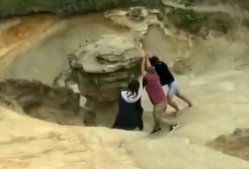 Photo: group destroying a rock structure atop the cape nicknamed Duckbill Rock